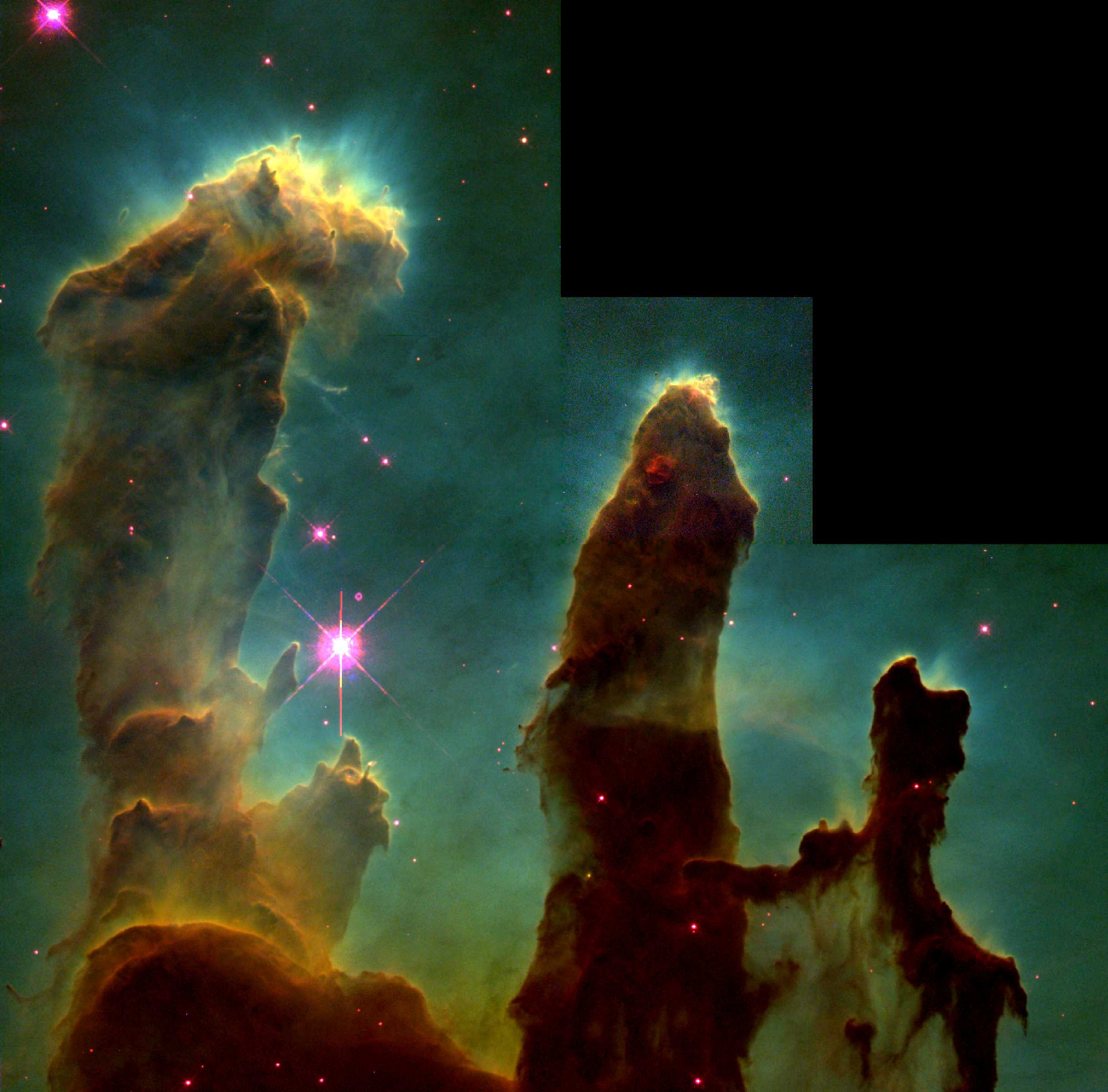 鹰星云内部的气体柱“创生之柱”，长度约一光年。顶部的云气正在蒸发，表示有新生的恒星正在发散恒星风，将物质吹散。